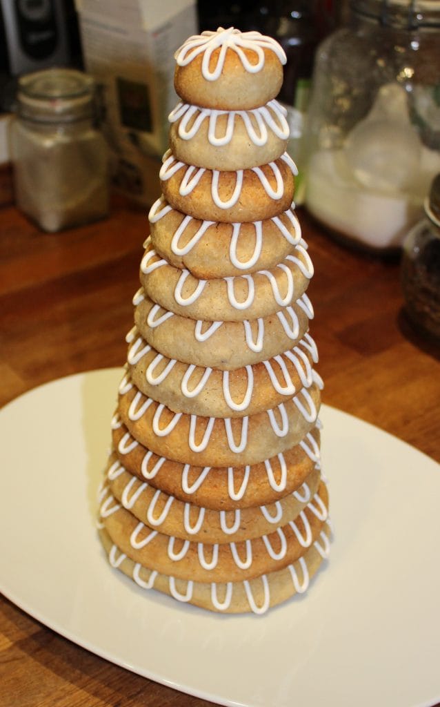 Danish Kransekage tower - marzipan wreath cake or ring cake - a recipe for a classic Danish cake. Use it for weddings, Christmas, New Year, or any party that needs a fancy cake. Find recipes and inspiration @ danishthings.com #DanishThings #kransekage # marzipanwreathcake #ringcake #Danish #tradition #weddingcake #NewYear #christmas #cake #party #classic #festive #tower