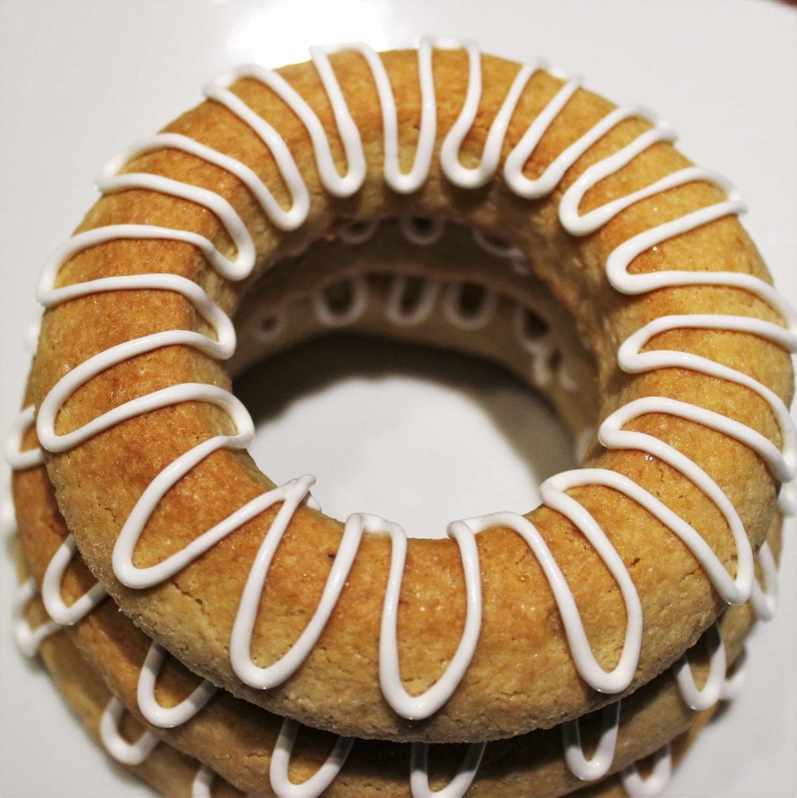 Danish Kransekage tower - marzipan wreath cake or ring cake - a recipe for a classic Danish cake. Use it for weddings, Christmas, New Year, or any party that needs a fancy cake. Find recipes and inspiration @ danishthings.com #DanishThings #kransekage # marzipanwreathcake #ringcake #Danish #tradition #weddingcake #NewYear #christmas #cake #party #classic #festive #tower