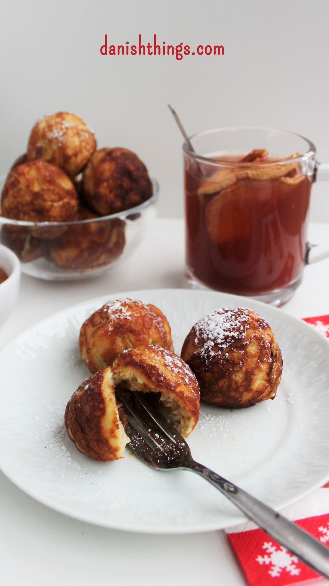 Aebleskiver - Puff dumplings - Apple dumplings - Filled pancakes - Pancake balls – in Danish æbleskiver. The most delicious filled aebleskiver. Danes eat them at Christmastime – you can eat them whenever you like. Fill your aebleskiver with apple compote, jam, marmalade or with extra batter and have nice round aebleskiver. Eat them as they are or serve them with sugar and marmalade. Find the recipe and inspiration for your Danish inspired Christmas @ danishthings.com #DanishThings # Aebleskiver #Puff-dumplings #Apple-dumplings #Filled-pancakes #Pancake-balls #round #pancakes #sweet #dumpling #Danish #æbleskiver #Christmas